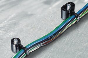 This outside serrated cable tie with weld stud mounting keeps the cables close to the fixing stud.